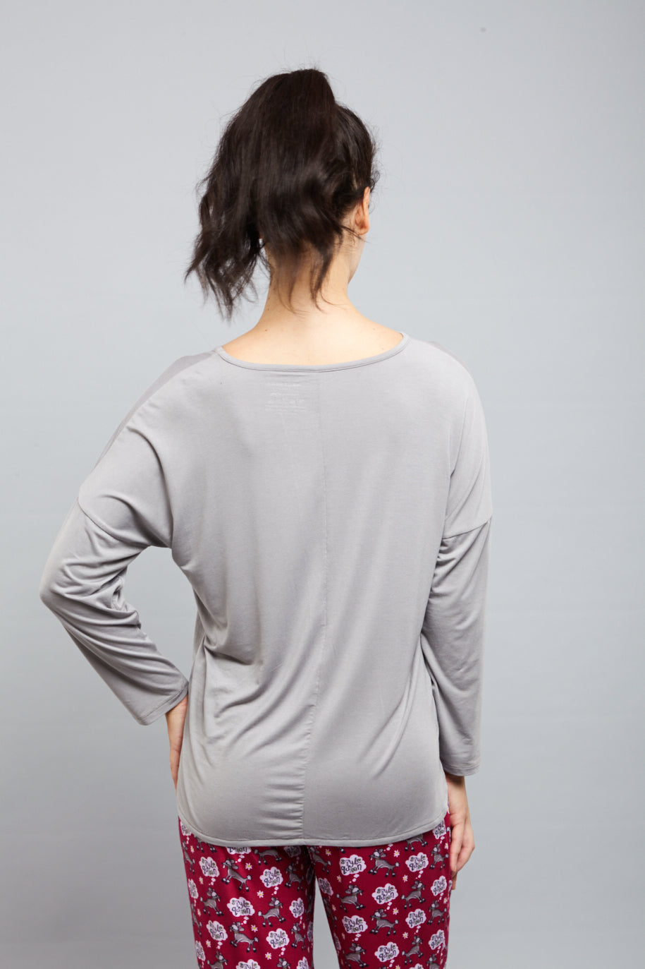 Back view of a woman wearing a dreamy grey top.