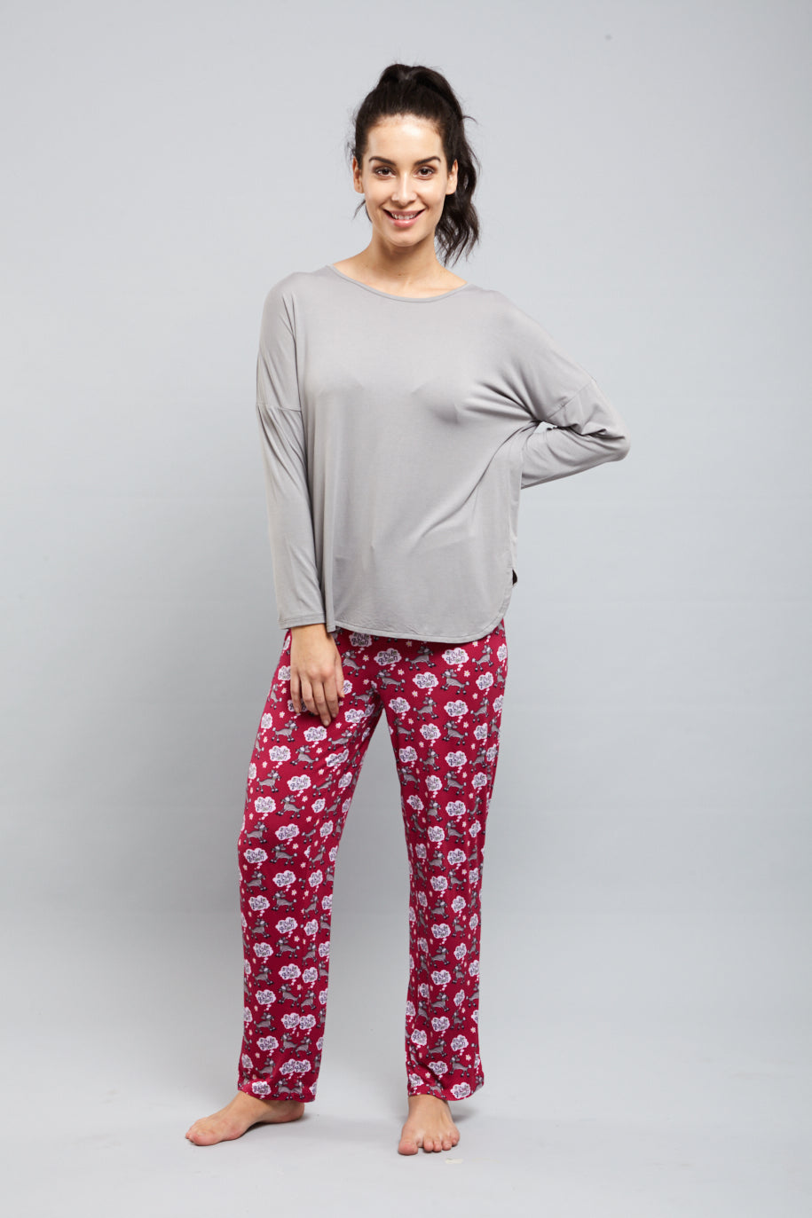 Woman modeling stylish gray and patterned pajama set for comfort.