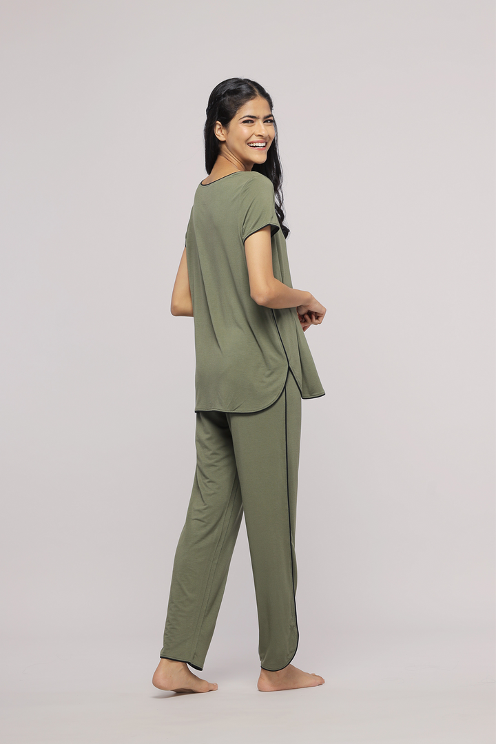 Olive green multipurpose lounge set worn by a smiling model.